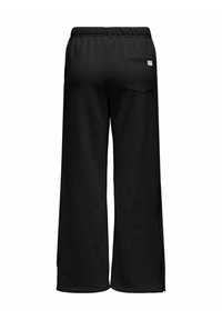 Pantaloni de jogging negri cu croială largă, dintr-un material moale, având o talie elastică și un singur buzunar pe spate cu etichetă.