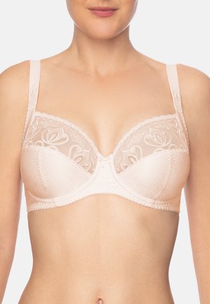 Reggiseno beige con dettagli in pizzo, spalline regolabili e un tessuto testurizzato. Il design presenta motivi floreali e una finitura liscia.