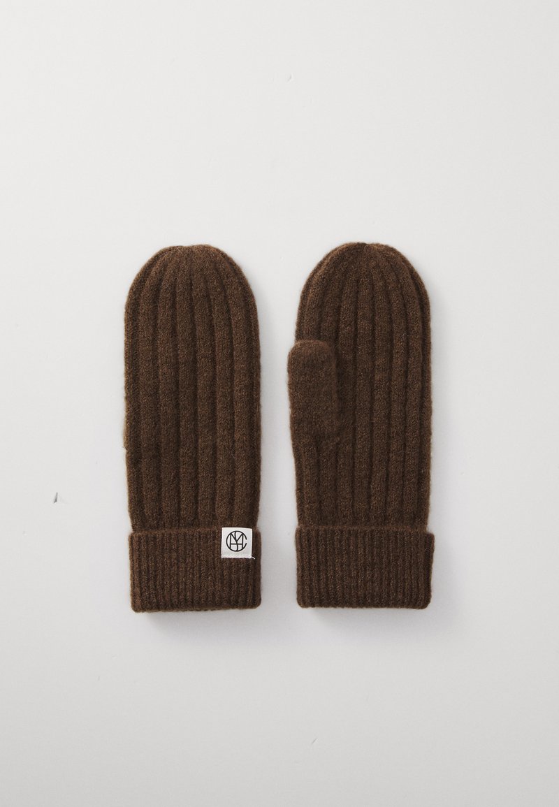 Brown ribbed knit mittens with folded cuffs, one featuring a small white tag with a black circular logo, laid flat on a white background.