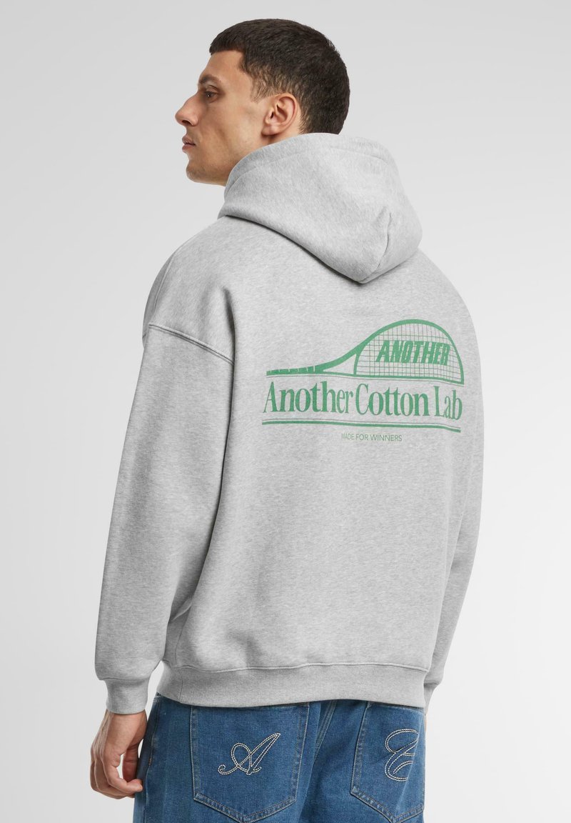 Gray cotton hoodie with a drawstring hood; features a green printed logo on the back reading "Another Cotton Lab" and "Made for Winners."