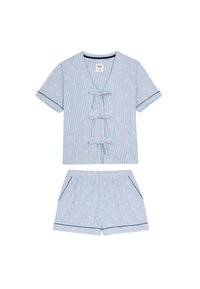 Svetle modrý pruhovaný pyžamový set, který obsahuje top s krátkým rukávem s růžovým hvězdičkovým vzorem, zavazování na mašli a odpovídající šortky s kapsami a tmavě modrým lemováním.