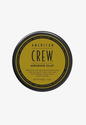American Crew Molding Clay -hiustuote, jossa musta kansi ja keltainen etiketti, 85 g, tarjoaa vahvan pitoisuuden ja keskikirkkauden.