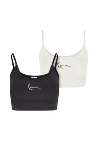 Two crop tops in black and white, made of smooth fabric, featuring thin straps and a minimalist signature logo in contrasting color.