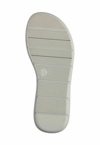 Suola di scarpa in gomma bianca con una superficie testurizzata, caratterizzata da scanalature orizzontali e perforazioni circolari per una presa migliore. Punta arrotondata.