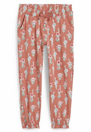 Rdzawo-pomarańczowe spodnie dziewczęce z różowym i niebieskim kwiatowym wzorem, elastycznym pasem ze sznurkiem, bocznymi kieszeniami i elastycznymi mankietami przy kostkach.