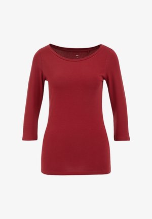 Vörös, hosszú ujjú felső, széles dekoltázzsal. Puha anyagból készült, fitted kialakítással és sima textúrával rendelkezik, alkalmas hétköznapi viseletre.