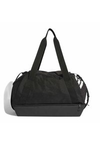 Bolsa de lona negra hecha de tela con un acabado texturizado, que cuenta con asas dobles y cierre de cremallera; incluye rayas blancas decorativas en el lateral.