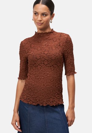 Brown, textured top with a high neckline, short ruffled sleeves, and a scalloped hem, featuring a floral pattern throughout.