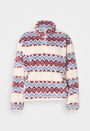 Fleece pullover met een hoge kraag en een meerkleurig zigzagpatroon in rood, blauw en crèmekleur. Zachte textuur en losse pasvorm.