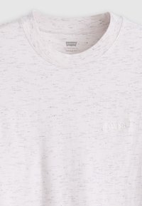 White cotton t-shirt with a textured finish, featuring a crew neck and a small, embossed Levi's logo on the chest.