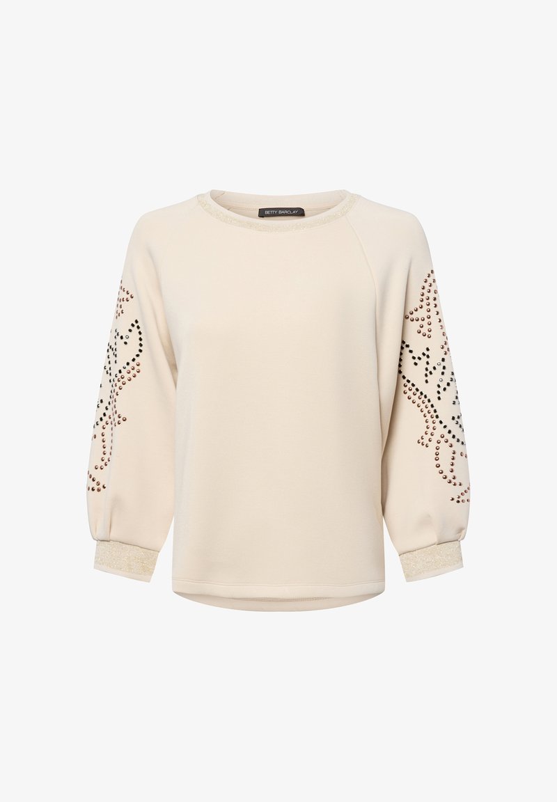 Cream long-sleeve sweatshirt with metallic-studded floral patterns on sleeves and glittery trim on collar and cuffs.