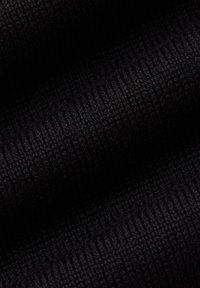 Zbliżenie na czarną dzianinę o ciasnej, równej prążkowanej fakturze z subtelnym światłem i cieniem na fałdach.