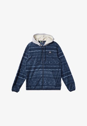 Navy-blue zip-up hoodie with gray hood lining, featuring a geometric pattern in various shades of blue and a kangaroo pocket.