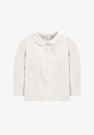 Košulja dugih rukava od svijetle kremaste pamučne tkanine s okruglim ovratnikom, dvostrukim kopčanjem na dugmad i čipkastim rubom uz ivicu ovratnika.