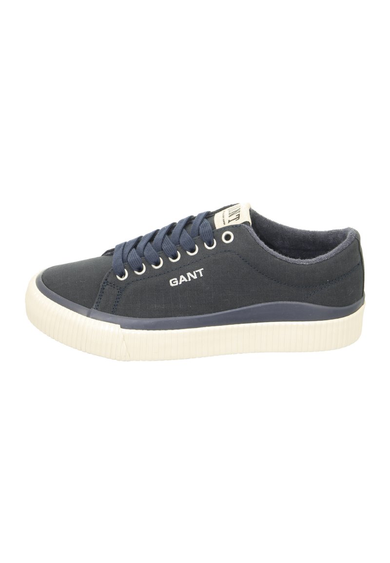 Navy canvas sneakers with white rubber sole, round toe, and blue laces. Features “GANT” logo on the side and textured surface.