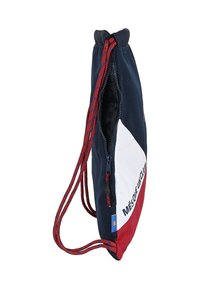Sac à cordon bleu marine et blanc avec des accents rouges, fabriqué en tissu durable ; dispose d'une surface texturée et d'un texte imprimé sur le côté.