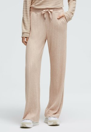 Light pink ribbed lounge pants with a drawstring waist, side pockets, and a relaxed fit. Soft texture and straight leg design.