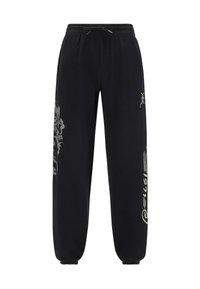 Svarta svettbyxor med dragsko i midjan, avsmalnande muddar och ljusa grafiska mönster på vänster ben och sidan. Mjuk textur.