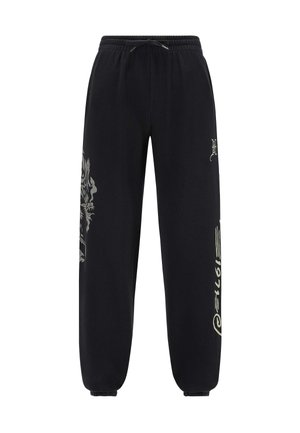 Pantalones de chándal negros con cintura ajustable, puños estrechos y diseños gráficos de colores claros en la pierna izquierda y el costado. Textura suave.