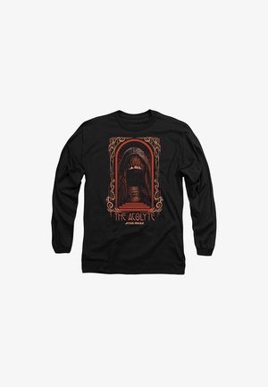 Black long-sleeve shirt featuring an orange graphic of a hooded figure inside an ornate frame with the text "THE ACOLYTE" and "STAR WARS."