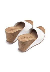 White wedge sandals with a cork footbed, featuring a smooth upper and a wide strap. Textured brown outsole for traction and stability.