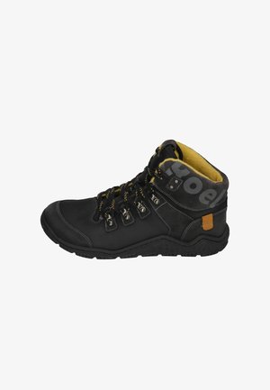 Black hiking boot with yellow accents, textured leather upper, robust rubber sole, metal eyelets, and padded collar for comfort.