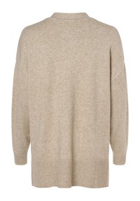 Beżowy dziergany kardigan o luźnym kroju, z długimi rękawami oraz ściągaczami na mankietach i dole. Materiał ma miękką, teksturowaną powierzchnię.