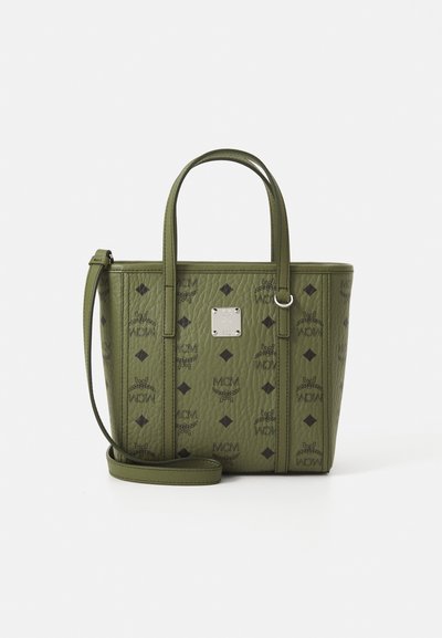 Small olive green leather tote with black diamond and MCM logos, dual handles, detachable shoulder strap, and metal logo plate on front center.
