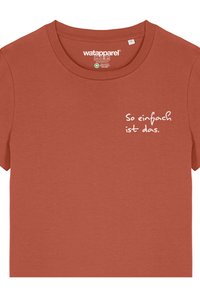 Rostfarbendes T-Shirt aus weichem Stoff, mit kurzen Ärmeln und rundem Halsausschnitt. Auf der Vorderseite steht in weißem Text: "So einfach ist das."