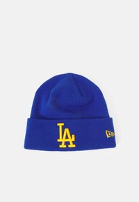 Blå strikket lue med en gul brodert "LA"-logo foran og en liten logo-detalj på siden. myk og stretchy tekstur.