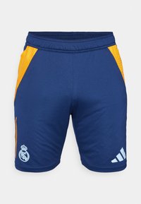 Siniset urheilu shortsit, joissa on oranssit verkkokankaat sivuilla. Liitteenä valkoinen Adidas-logo ja Real Madridin vaakuna. Mukavuuden vuoksi joustava vyötärö.