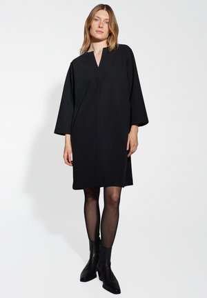 Zwarte wollen blend jurk met een V-hals, verlaagde schouders en driekwart mouwen, met een rechte pasvorm die boven de knie valt.