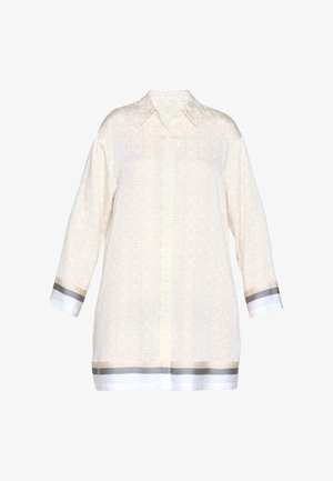 Chemise crème à manches longues avec boutonnière, motif subtil à carreaux et rayures blanches, beiges et grises sur les poignets et l'ourlet.