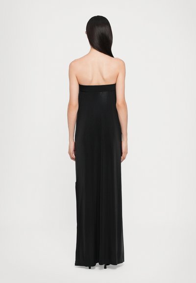 Black, strapless maxi dress with a fitted bodice, flowing fabric, and a subtle texture. Features side pockets and a straight hem.
