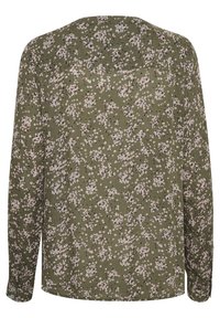 Grünes Langarmshirt mit einem floralem Muster in Pink und Weiß. Weicher Stoff mit lockerer Passform und subtiler Nahtdetail auf dem Rücken.