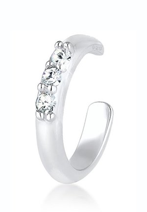 Silberner offener Ring mit drei runden klaren Edelsteinen, die in einer Reihe entlang der vorderen Kurve des Rings eingefasst sind.