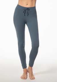 Leggings in een gemuteerd blauw-grijze kleur, gemaakt van zacht stof. Beschikt over een trekkoord in de taille en aansluitende enkels voor een gestroomlijnde silhouet.