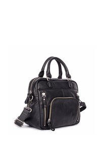 Sac à main en cuir noir avec deux poignées supérieures, une bandoulière réglable et plusieurs poches zippées. Texture lisse et design compact.