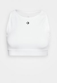Bílý crop top vyrobený z hladkého materiálu, s kulatým výstřihem a černým hvězdným logem na levé části hrudi. Elastický spodní lem s minimálními švy.