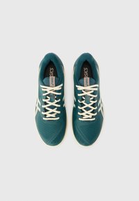 Teal athletic shoes made of breathable mesh with white laces and side stripes. Features a textured sole and padded collar for comfort.