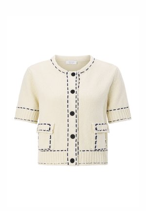 Short-sleeve cardigan in cream fabric with textured finish, navy stitching, round neck, and two front pockets with flaps. Five black buttons.
