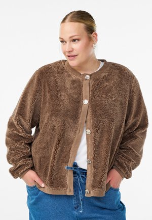 Brown fuzzy jacket made of textured fleece, featuring a round neckline, button closure, and soft fabric. Styled with relaxed fit and pockets.