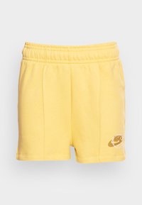 Shorts de sport en coton jaune avec une taille élastique. Ils présentent des coutures latérales et un logo imprimé sur le bas à gauche, à l'avant.