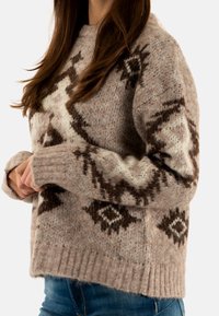 Light brown sweater with geometric patterns in dark brown and cream. Ribbed cuffs and hem, made of soft, textured knit fabric.