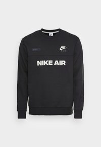 Svart sweatshirt med rund hals, långa ärmar och ribbade mudd. Har "NIKE AIR"-logotypen i vitt och en liten Nike-logotyp på bröstet.