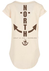 Light beige short-sleeve T-shirt featuring a large brown "NORTH" graphic and arrow designs on the back, with additional text and a logo.