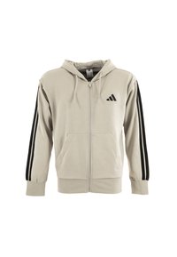 Felpa beige con zip realizzata in cotone morbido. Presenta un cappuccio, due tasche frontali e strisce verticali nere a contrasto sulle maniche.