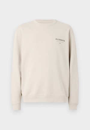 Beige crewneck sweatshirt i mjukt material. Har ribbade muddar och nederkant, med "ALLSAINTS"-logotyp tryckt i brunt på bröstet.