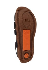 Brown, textured sole with an orange label featuring eco-friendly messaging; includes a flower motif and markings for size 36.