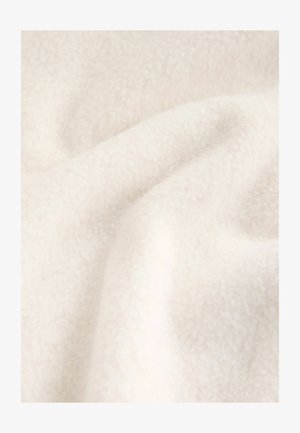 White fleece fabric with a soft, textured surface, showing gentle folds and creases, highlighting its pliable and cozy appearance.